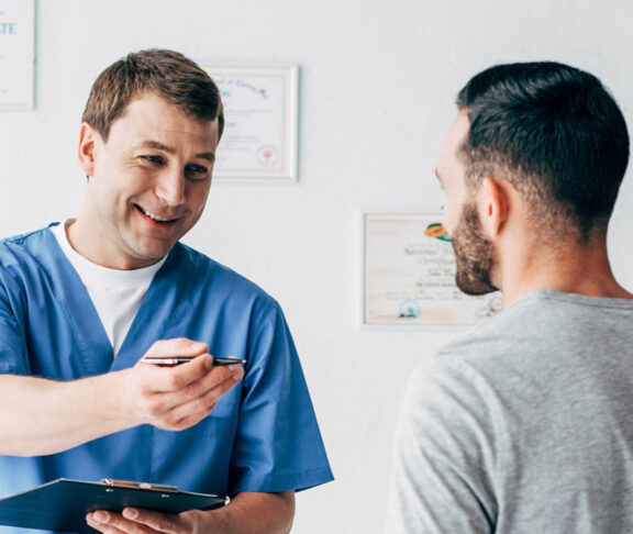 panoramic shot of smiling Physiotherapist with diagnosis near patient in hospital
