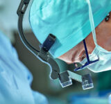 Female surgeon in operation room with reflection in glasses