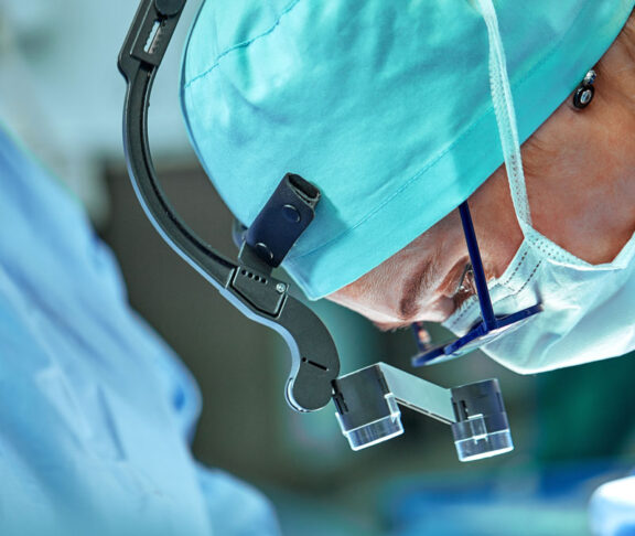 Female surgeon in operation room with reflection in glasses