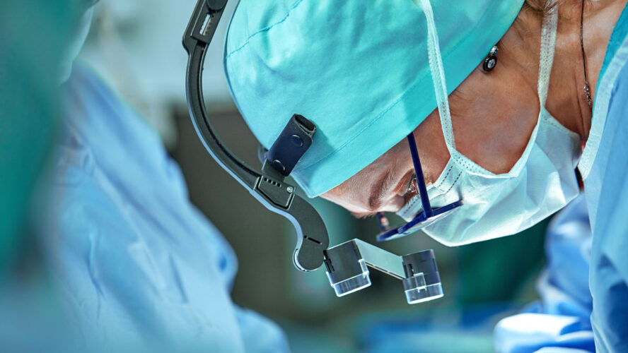 Female surgeon in operation room with reflection in glasses
