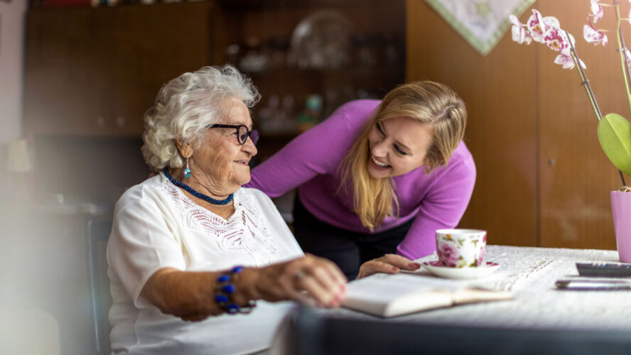 Young woman spending time with her elderly grandmother at home