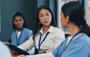 Medical team, tablet and consulting in hospital with doctor, meeting and diversity at work. Healthcare, nursing and health support staff with tech for patient info or test results and communication