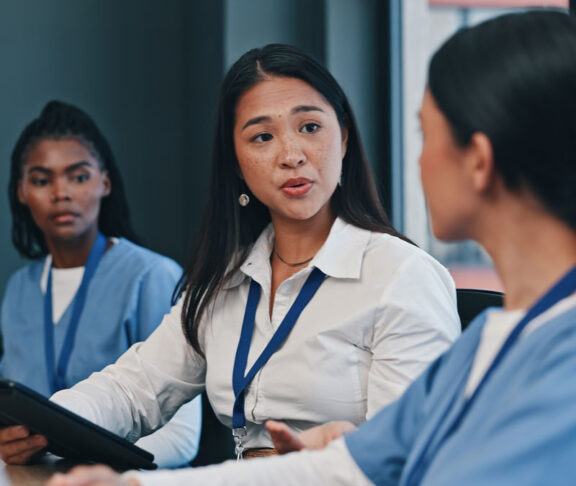 Medical team, tablet and consulting in hospital with doctor, meeting and diversity at work. Healthcare, nursing and health support staff with tech for patient info or test results and communication