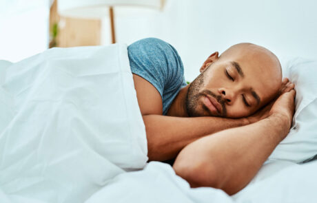 Cropped shot of a young man sleeping in his bed