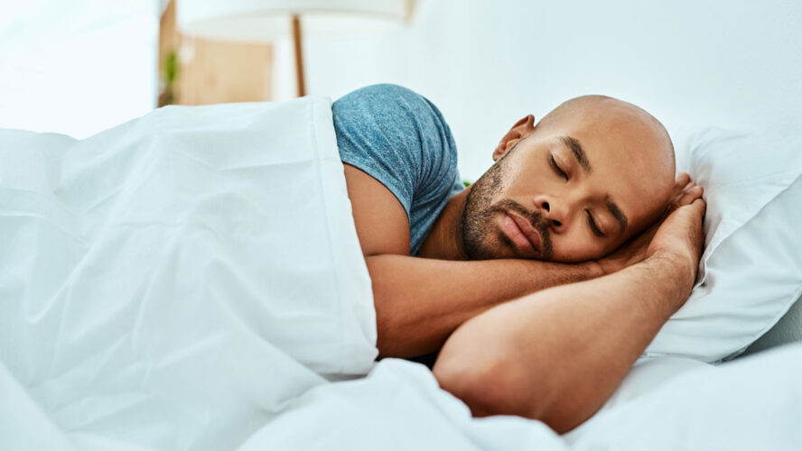 Cropped shot of a young man sleeping in his bed