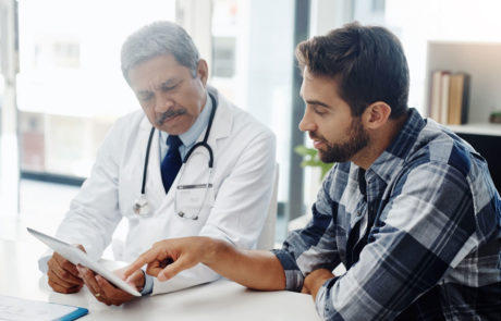 Cropped shot of a mature male doctor and patient having a discussion in the doctor's office before a checkup