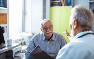 Close up of a doctor having good news for his senior patient