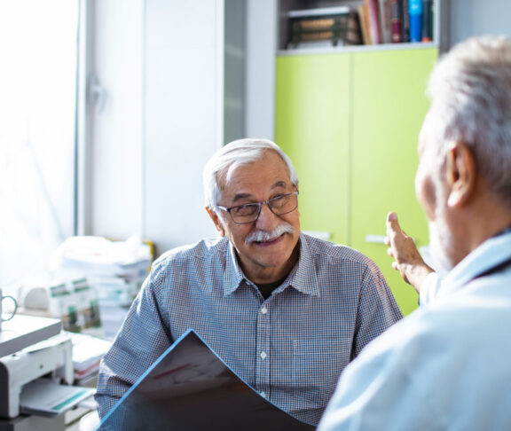 Close up of a doctor having good news for his senior patient