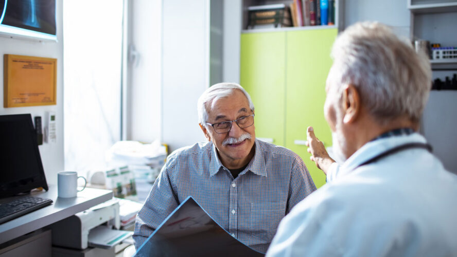 Close up of a doctor having good news for his senior patient