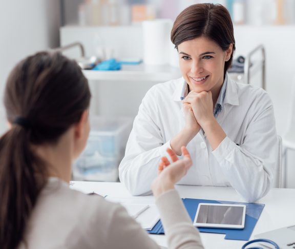 Doctor working in the office and listening to the patient, she is explaining her symptoms, healtcare and assistance concept