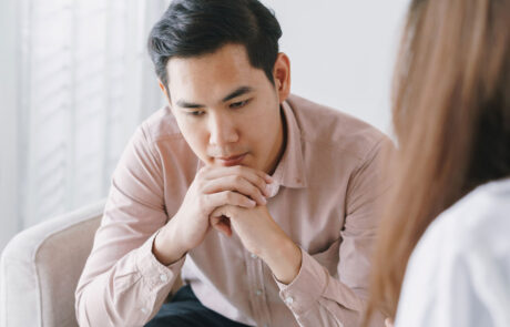 Male Asian patient with psychologist women examination consulting and psychotherapy by the physician in the clinic
