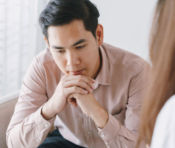 Male Asian patient with psychologist women examination consulting and psychotherapy by the physician in the clinic