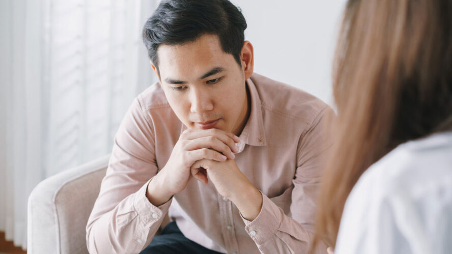 Male Asian patient with psychologist women examination consulting and psychotherapy by the physician in the clinic