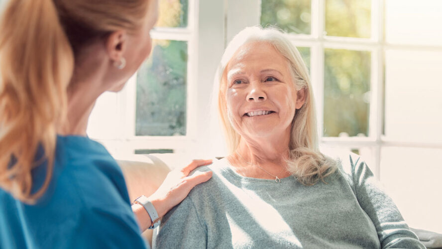 Shot of a senior woman being supported by her nurse at home