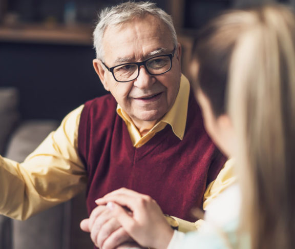Home doctor is visiting senior man to check his health. Professional caregiver is assisting old man at his home.