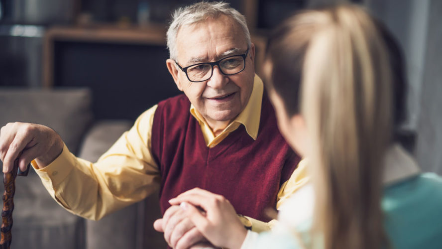 Home doctor is visiting senior man to check his health. Professional caregiver is assisting old man at his home.