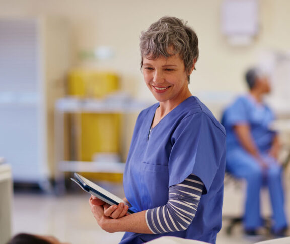 Shot of a nurse standing by her patient's bedside