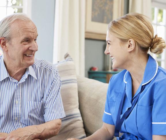 Female Community Nurse Visits Senior Man At Home