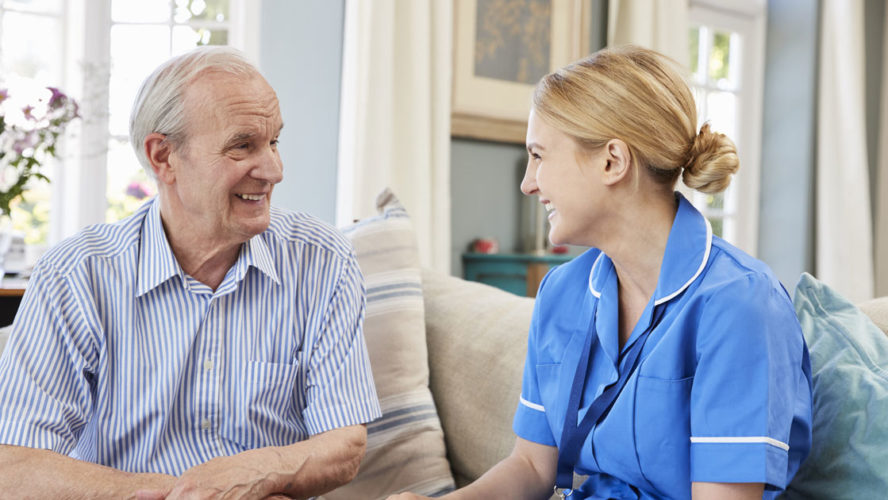 Female Community Nurse Visits Senior Man At Home