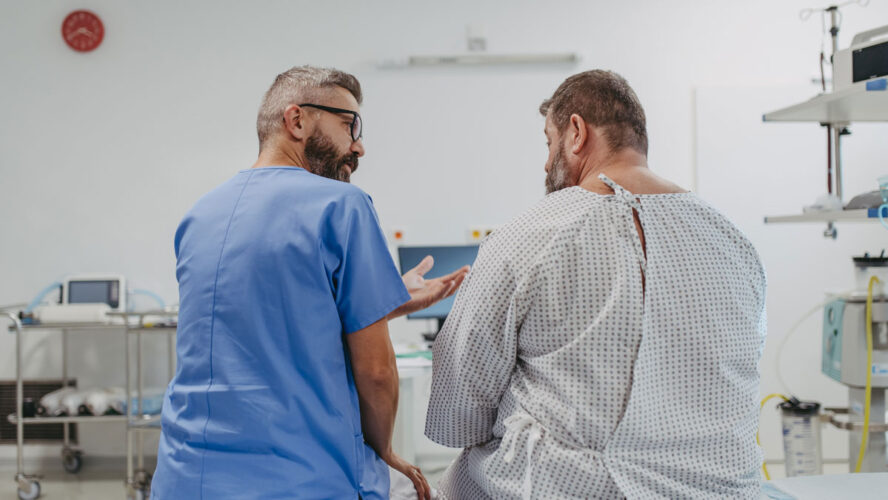 Supportive doctor soothing a worried overweight patient, discussing test result in emergency room. Illnesses and diseases in middle-aged men's health. Compassionate physician supporting stressed