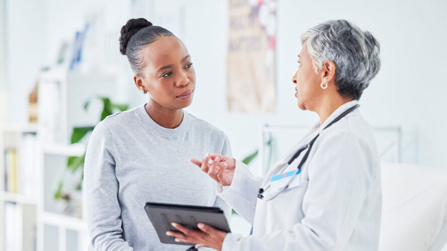 Doctor, woman and tablet for hospital, healthcare advice and support for results, exam and test on bed. Senior expert or medical people on digital tech for clinic sign up, registration and consulting