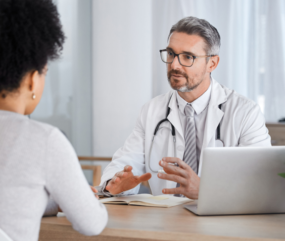 Healthcare, consultation and doctor talking to woman in after checkup