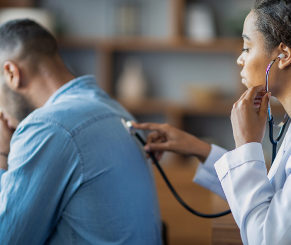 general practitioner checking sick man lungs with stethoscope